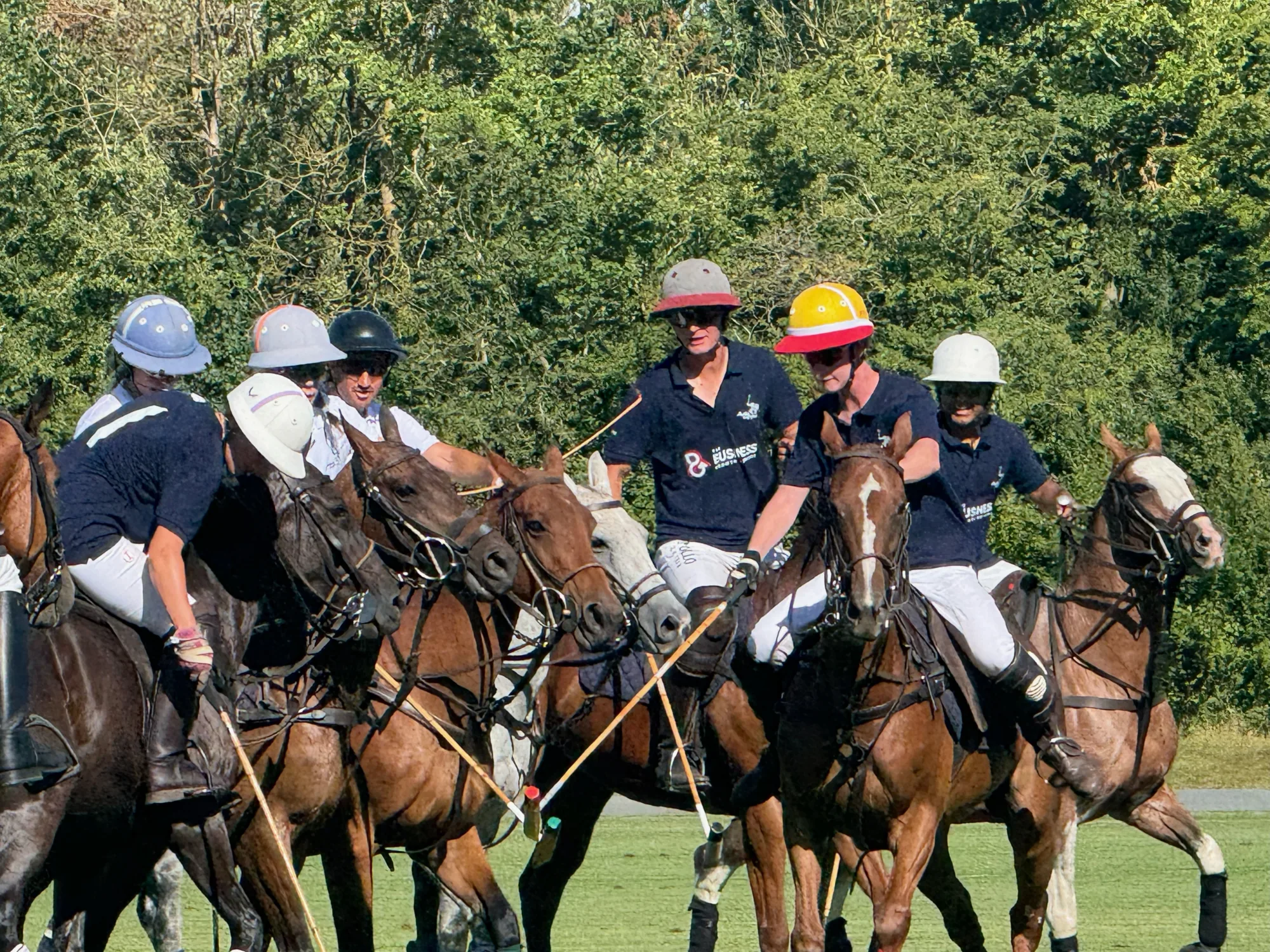 Polo players and horses gathering on the field